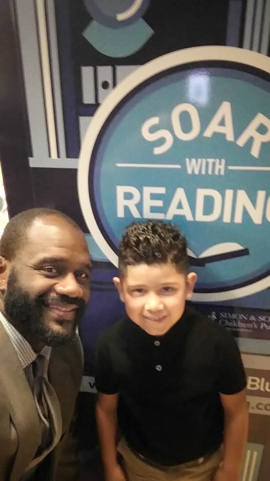 Jerry Davis with a young reader at a Soar With Reading literacy event